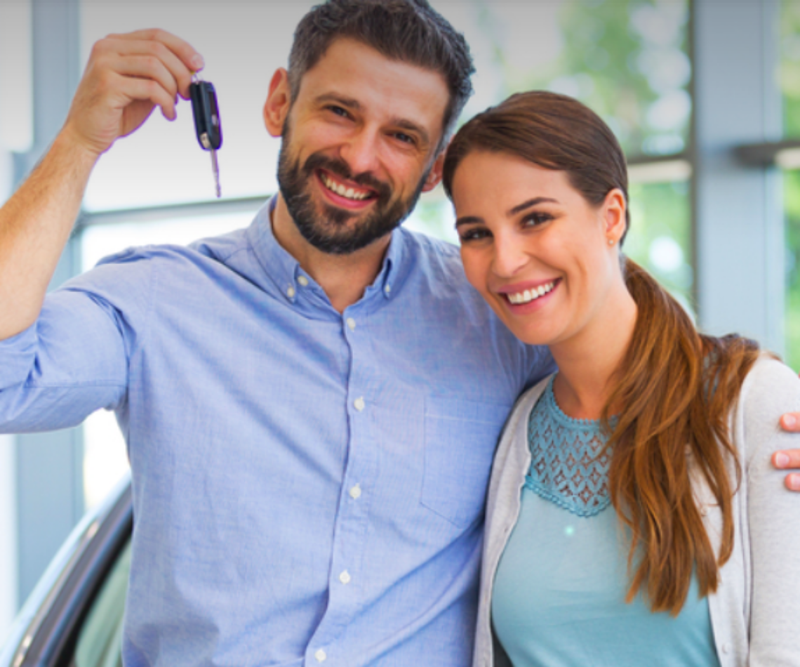 A happy couple who just purchased a car