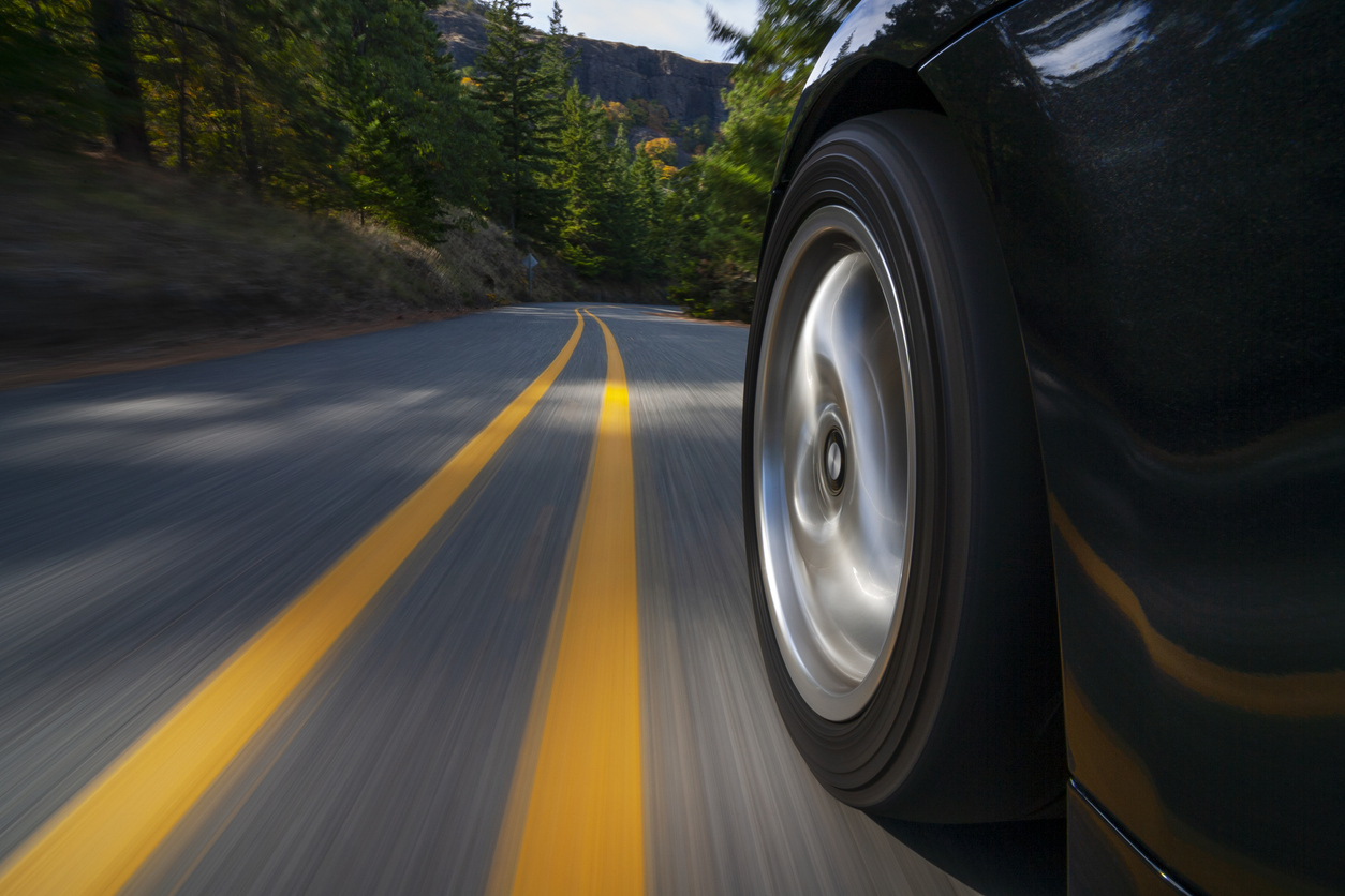 Black sports car motion country road.