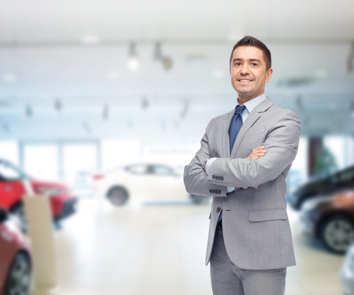 happy man at auto show or car salon