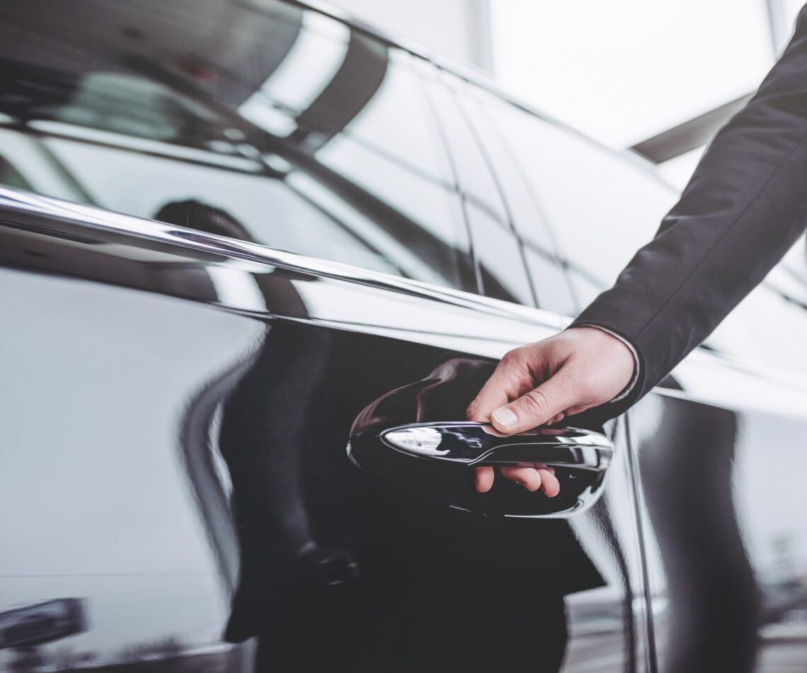 businessman opening a car door