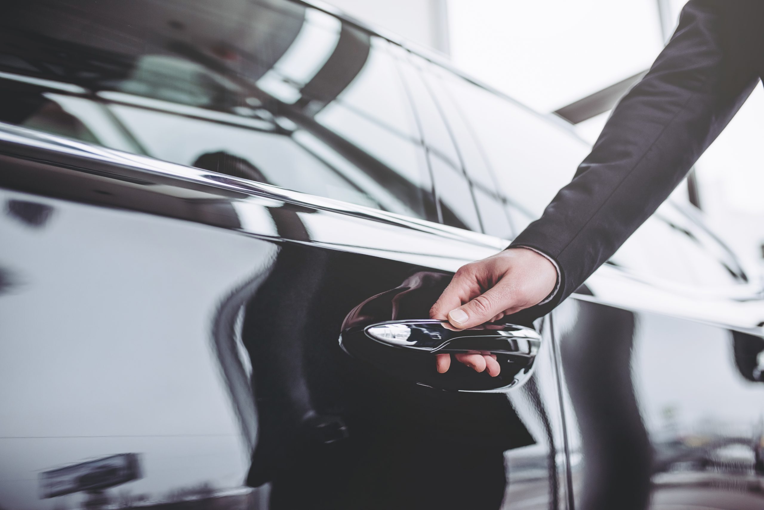 businessman opening a car door