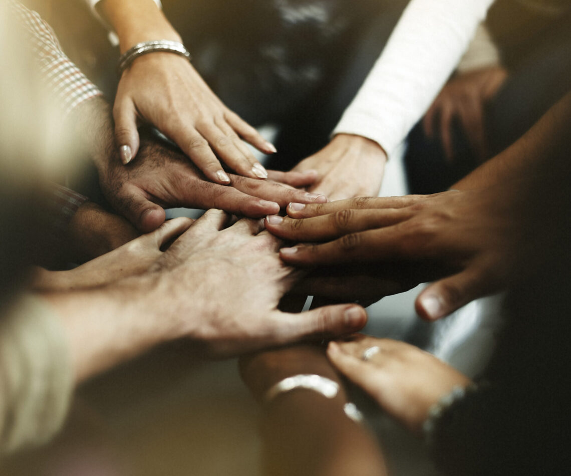 Closeup of diverse people joining their hands