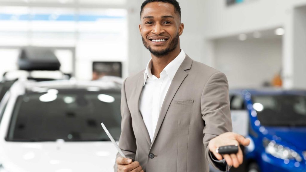 Car Dealer Offering Automobile Key